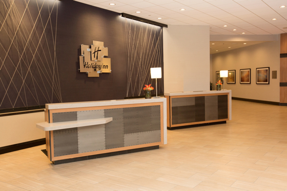 Custom stainless steel aircraft cables and riveted panels accent the reception desk.