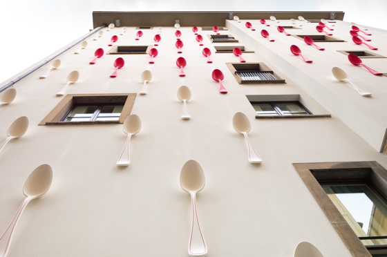The façade of the Gallery Hotel Art in Florence is covered with larger-than-life spoons as part of Simone D’Auria’s “Spoon – I eat earth.”