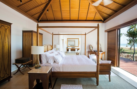 The four-poster bed in the villas reflects British style and is flanked by two nightstands inspired by Indian forms and materials such as beaten metal.