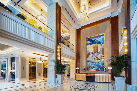 A lobby mural by celebrated Art Deco Artist Michael Kungl depicting wartime factory workers set on the backdrop of the New Orleans skyline