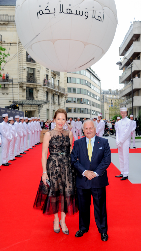 Lady Betty and Sir Michael Kadoorie arrive at the party as Montgolfier balloons and the Peninsula Pageboys stand watch in the background.