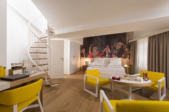Artwork makes a focal point, while yellow chairs spice up the space.