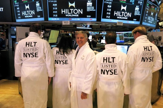 Hilton Worldwide CEO Chris Nassetta wears a Hilton Worldwide bathrobe made for the IPO on the floor of the New York Stock Exchange on Thursday.