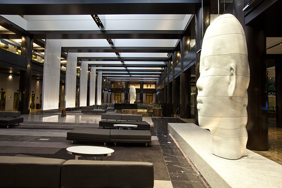 The lobby centerpiece is the larger-than-life installations by Jaume Plensa, reminiscent of the Moai sculptures on Easter Island.
