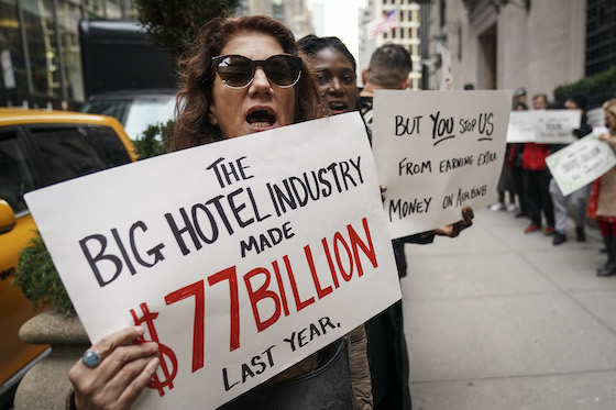 Supporters of home-sharing sites held a small rally in November outside the InterContinental New York Barclay Hotel, where hotel industry executives and New York City officials held a conference on how to better regulate Airbnb and other platforms. (Getty Images)
