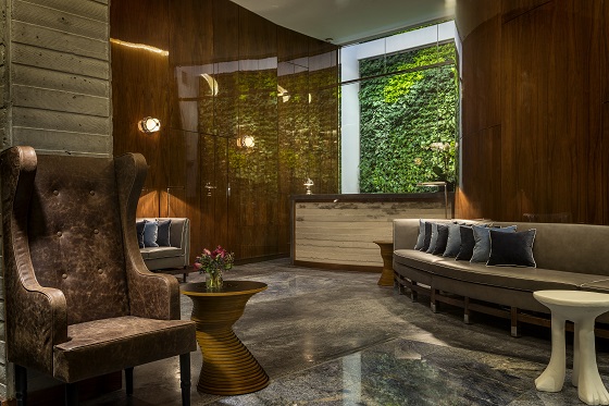 A green wall adds a modern flair to the lobby.