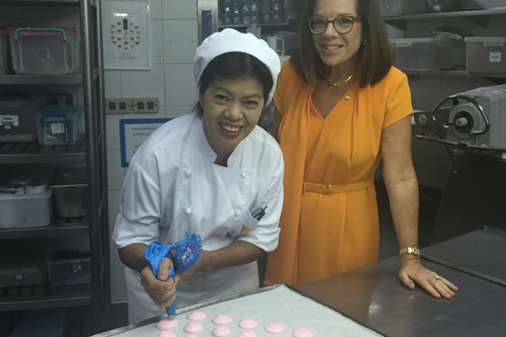 Mandarin GM Amanda Hyndman in the kitchen with one of her macaroon bakers
