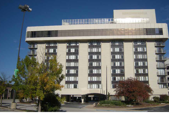 The exterior of the shuttered Renaissance Chicago Oak Brook Hotel was the same beige color as many of the buildings around it. 