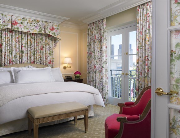 Garden-print fabrics in warm tones aim to balance neutral-patterned carpeting in the Superior Suite bedroom.