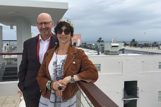 Jonathan Plutzik and Lesley Goldwasser by the rooftop pool on the air-bridge of The Betsy