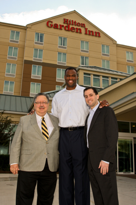 From left, Nick Massad, CEO of American Liberty with David Robinson and Dan Bassichis, co-founders of the Admiral Capital Group stand in front of the Hilton Garden Inn Houston Energy Corridor.