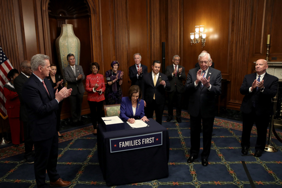 U.S. House of Representative leader Nancy Pelosi signs CARES Act (Getty Images)