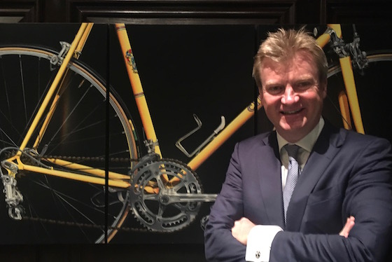 Philip Meyer in front of his favorite artwork in Rosewood Hotel Georgia, "Jaune,” a detailed Nickalas Blades painting of the yellow 1974 Cinelli bike that Greg LeMond raced from 1976-77