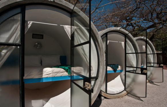 The pipe rooms do not feature a bathroom, simply a bed with a lamp and fan.