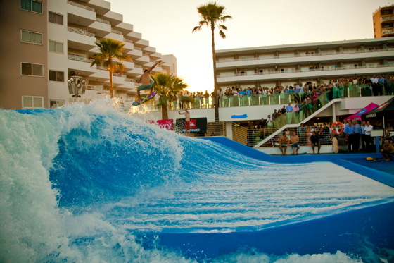 Spectators watch a surfer on the wave machine at Wave House Mallorca at the grand opening on Wednesday.
