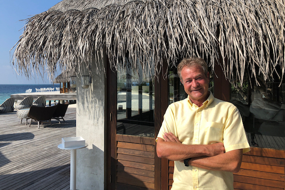 Jean-Christophe Nager in front of a thatched building, Huvafen Fushi