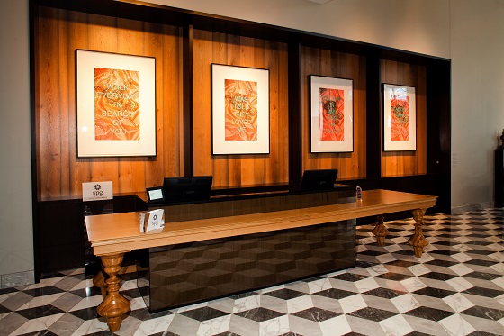 Warm wood tones form a backdrop for the artwork.